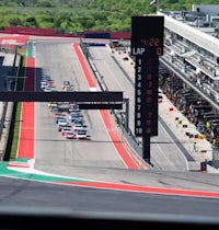 a race car driving down the track at a race track