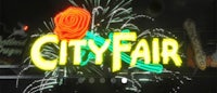 a neon sign with the word city fair on it