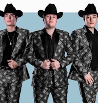 three men in cowboy suits posing for a photo